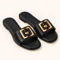 black buckle sandals on neutral background