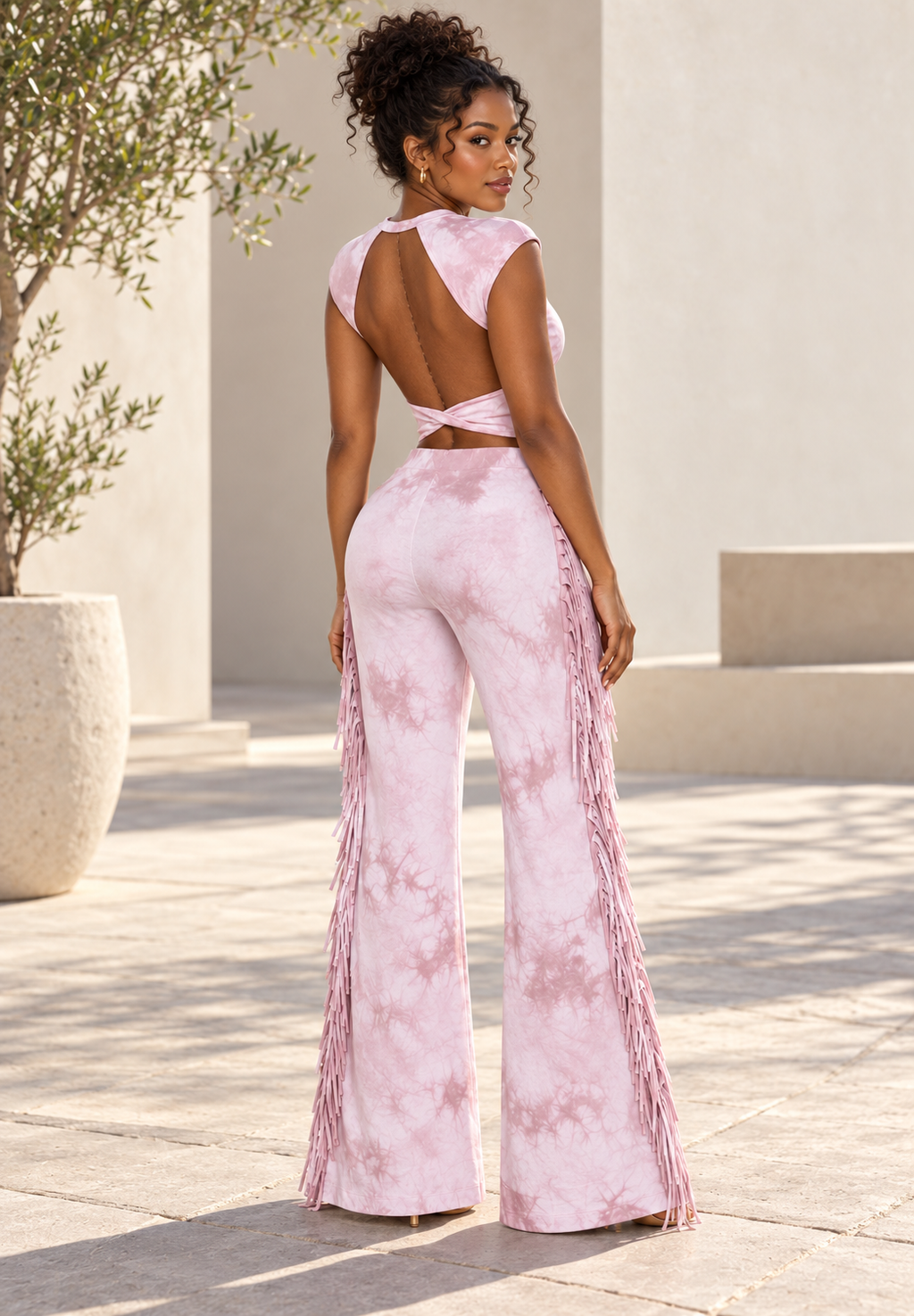 Blush pink tie-dye set on model, back view showing open back and side fringe