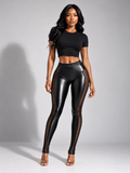 Front view of model wearing black mesh-panel leggings