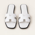 white fashion sandals on neutral background