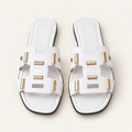 white gold accent sandals on neutral background
