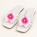 white orchid sandals on neutral background